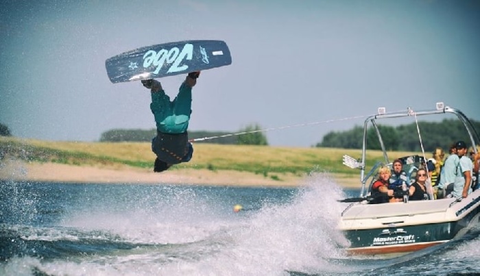jongen maakt salto met een wakeboard op watersport kamp in de biesbosch
