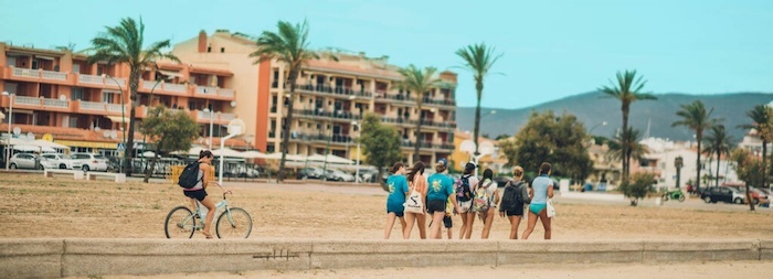 Jongen fietst langs de kust in Spanje tijdens een watersport vakantie