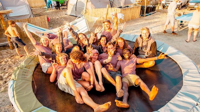 Jongeren genieten op een trampoline tijdens de jongerenreis surfen